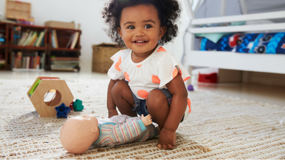 Black, African American Toddler Playing with Caucasian doll
